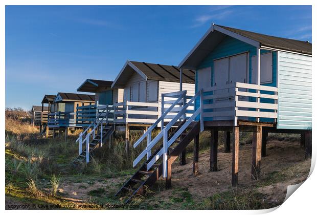 Row of beach huts Print by Clive Wells