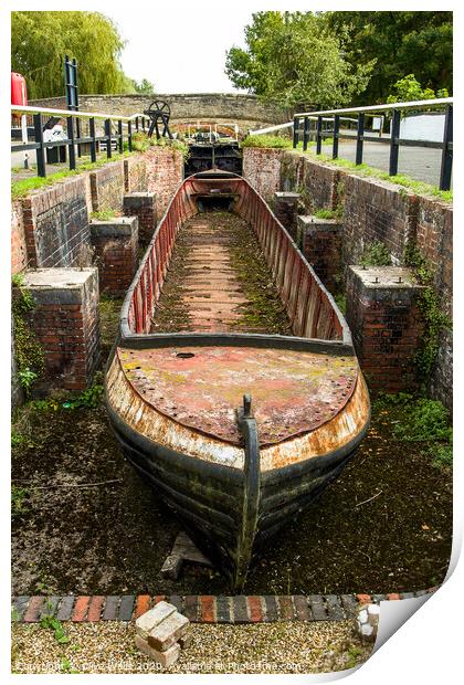 Abandoned shell of narrowboat at Stoke Brurne in N Print by Clive Wells