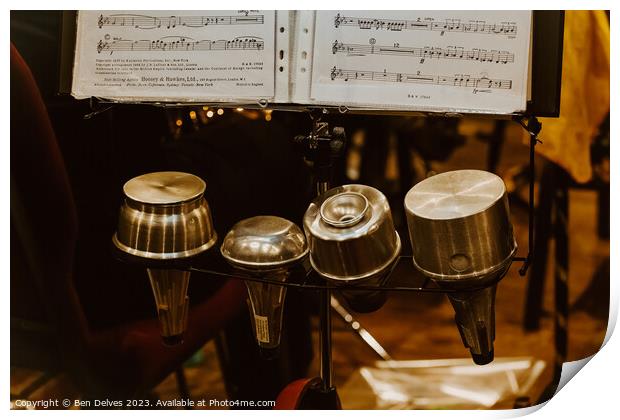 Trumpet mutes in a row with sheet music on a stand Print by Ben Delves