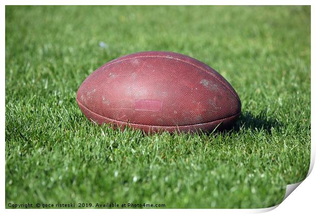 old American football ball on green grass Print by goce risteski