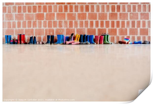Rubber rain boots on the floor at the entrance to a college clas Print by Joaquin Corbalan