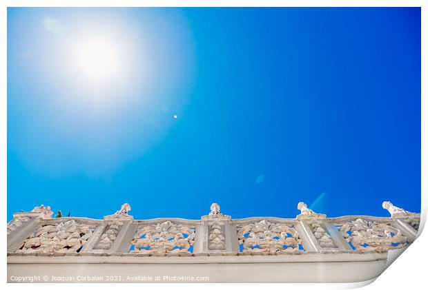 Old style stone balustrade, bottom view with blue sky background Print by Joaquin Corbalan