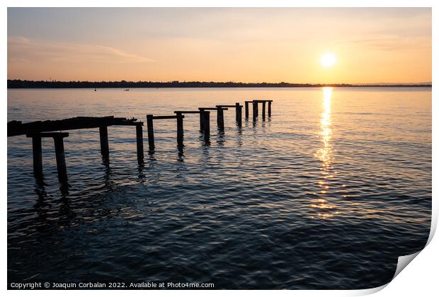 An old ramshackle pier with broken boards, during a beautiful su Print by Joaquin Corbalan