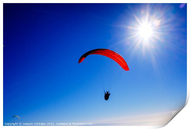 Paragliding above mountain peaks and white clouds during winter  Print by Joaquin Corbalan