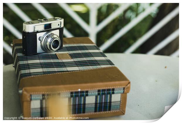 Old analog photo camera on a vintage travel suitcase. Print by Joaquin Corbalan