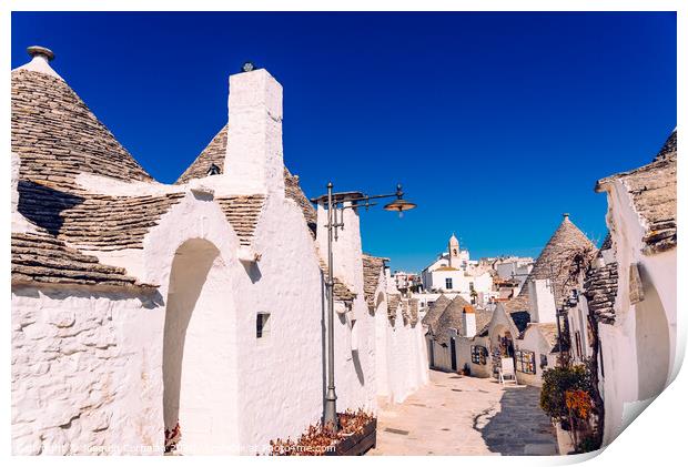 Narrow streets between the trulli of Alberobello, in southern Italy, ideal for family trips. Print by Joaquin Corbalan