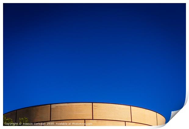 Background of intense blue sky in an industrial area with a brick construction with round shapes. Print by Joaquin Corbalan