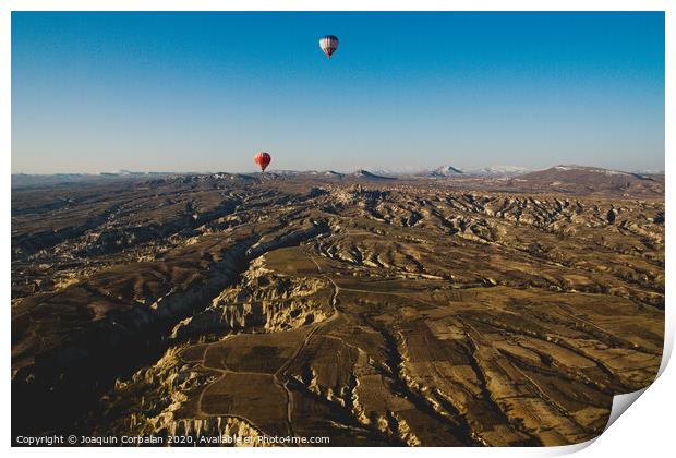 Colorful balloons flying over mountains and with blue sky in cappadocia Print by Joaquin Corbalan