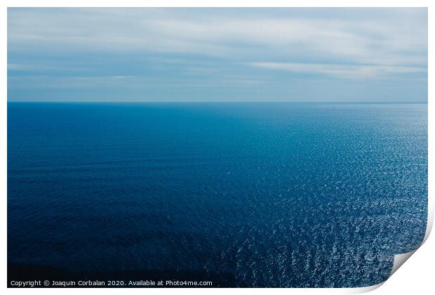 Calm blue sea without waves seen from a cliff with room for text Print by Joaquin Corbalan