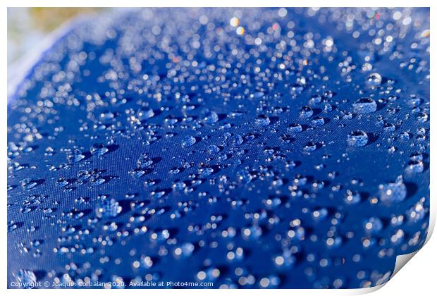 Detail of water drops on a plastic fabric colored in the sun. Print by Joaquin Corbalan