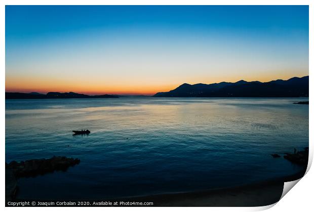 Sunset in a bay with mountains in the background and a small boat anchored. Print by Joaquin Corbalan
