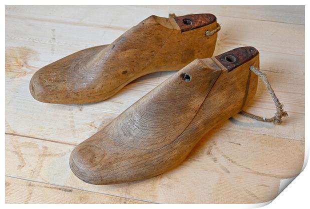 vintage wooden shoe lasts standing on wooden bench Print by Jonas Rönnbro