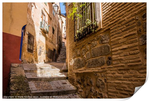 Medieval cobbled and stepped street in the city of Toledo. Spain Print by Mario Koufios