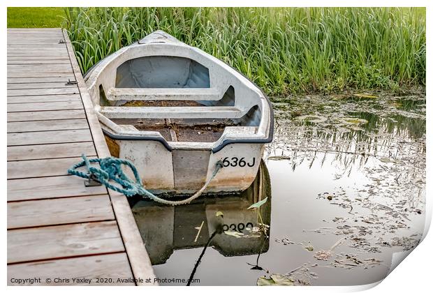 Boat tied to wooden staging on the Norfolk Broads Print by Chris Yaxley