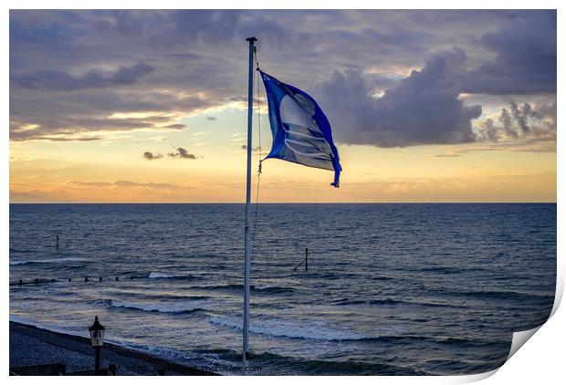 Flag flying in the breeze over Sheringham beach  Print by Chris Yaxley
