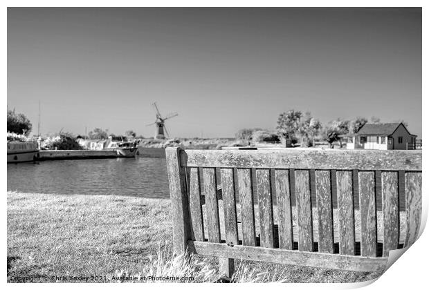 Wooden bench on the bank of the River Thurne Print by Chris Yaxley