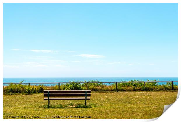 Empty bench on a hill on the ocean shore, green lu Print by Q77 photo