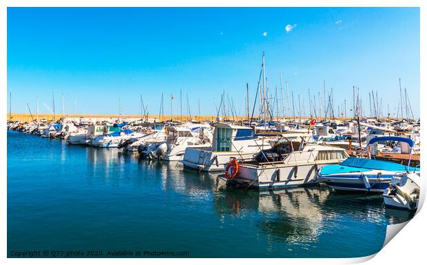 Beautiful luxury yachts and motor boats anchored in the harbor, hot summer day and blue water in the marina, blue sky Print by Q77 photo
