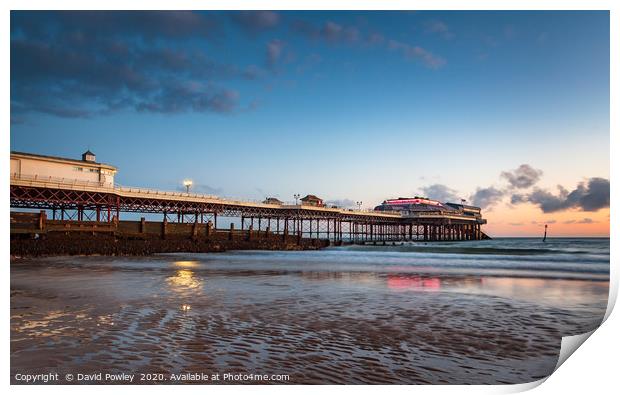 Dawn reflections of Cromer Pier Print by David Powley