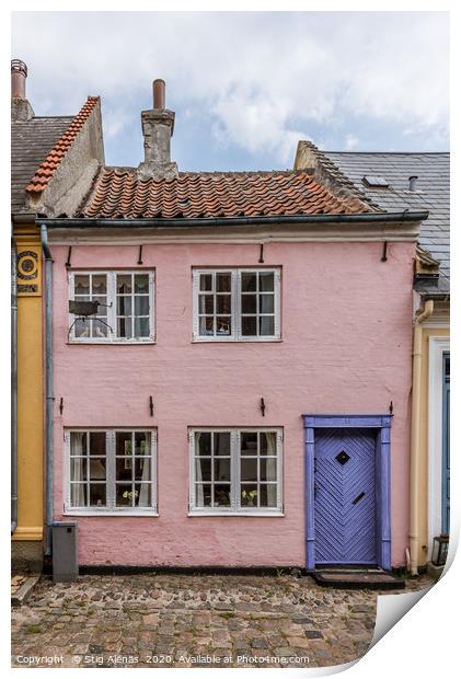 a small house in pink with a blue door on a cobble Print by Stig Alenäs