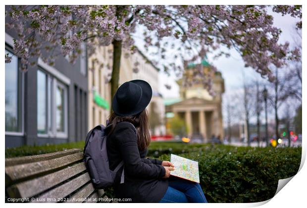 Woman looking at the Brandenburger Tor sited on a bank in Berlin, Germany Print by Luis Pina