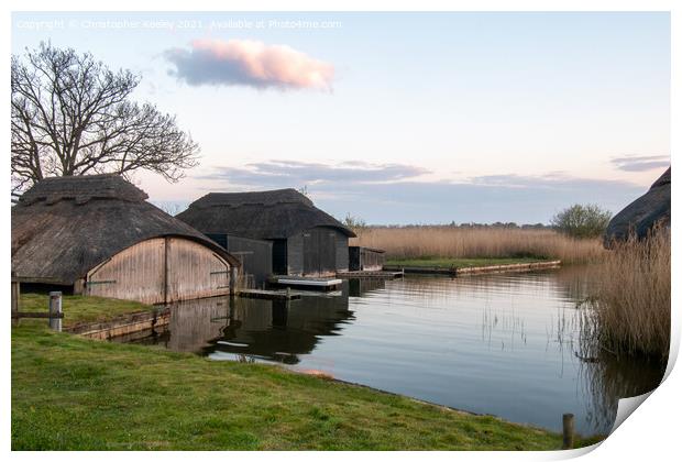 Hickling Broad boat houses Print by Christopher Keeley