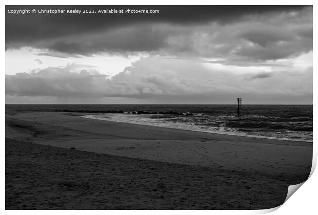 Moody, cloudy skies over Caister beach  Print by Christopher Keeley