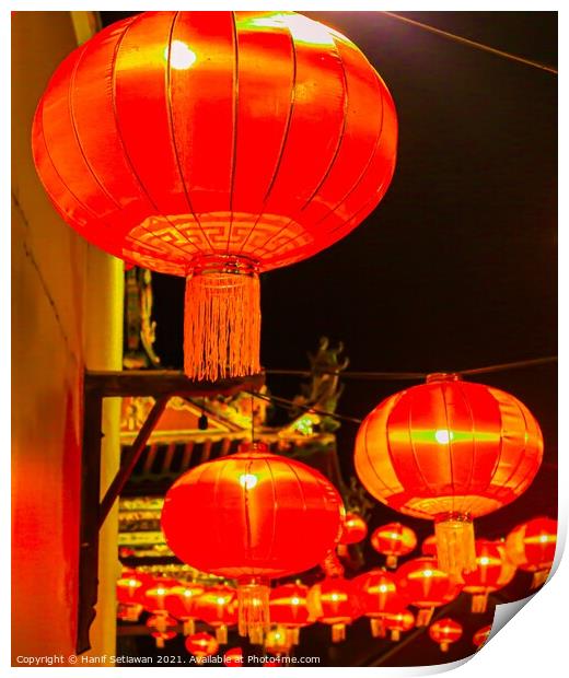 Red lantern as street lights hanging at a wall for Chinese New Year Print by Hanif Setiawan