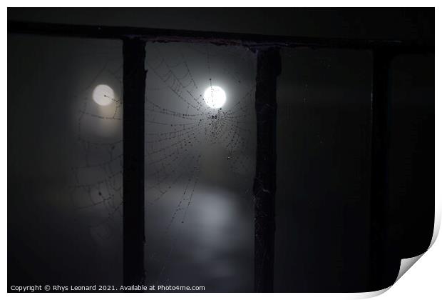 Spooky night time fog around a cobweb under railings with dew on it Print by Rhys Leonard