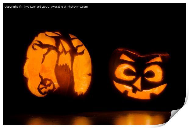 Two intricately carved halloween pumpkins lit by candle tea lights Print by Rhys Leonard