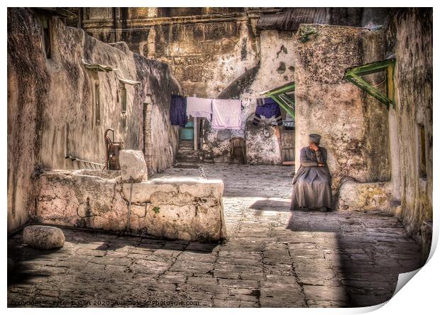 A backyard in Jerusalem old city with a resident sitting in deep contemplation.  Print by Peter Bolton