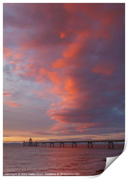 Clevedon Pier with the cloud cover catching the colourful sunlight Print by Rory Hailes