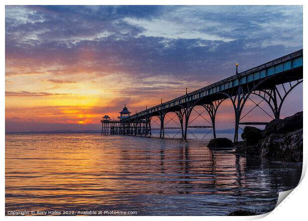 Pier at sunset with golden sunlight Print by Rory Hailes