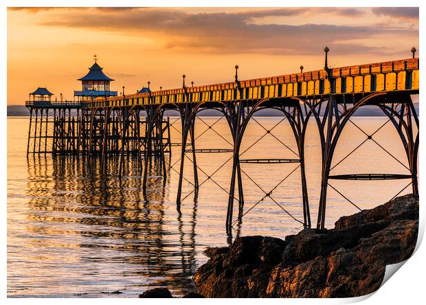 Clevedon Pier at Sunset sunlight reflecting onto the sea Print by Rory Hailes