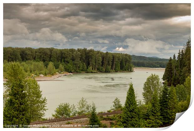 Fishermen fishing for salmon on the Skeena River below Terrace, during a cloudy day in summer, beside the CN Railway Line. Print by SnapT Photography