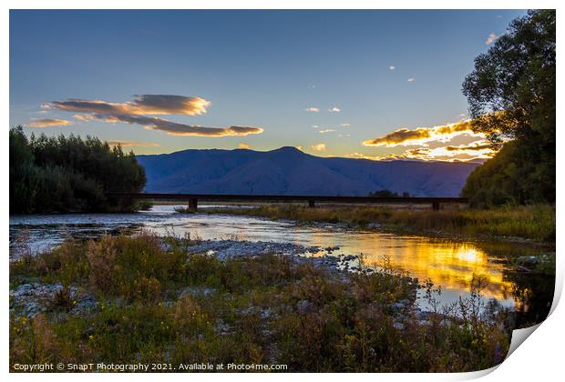 Sunset on the Tekapo River, with mountains in the background in summer Print by SnapT Photography
