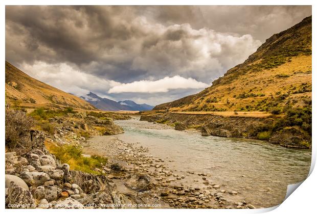 A mountain landscape and river on a cloudy day in New Zealand near Omarama Print by SnapT Photography