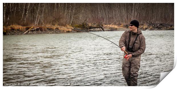 A fly fisherman hooked into a big fish in a river with the rod bent Print by SnapT Photography