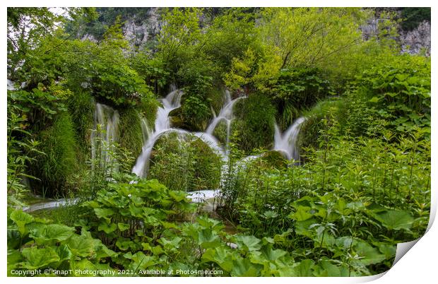 Water flowing through vegetation and over a waterfall at Plitvice Lakes Print by SnapT Photography