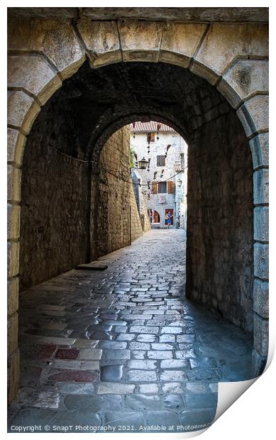 An alley way in the old town of Kotor, with flying brooms in the background Print by SnapT Photography