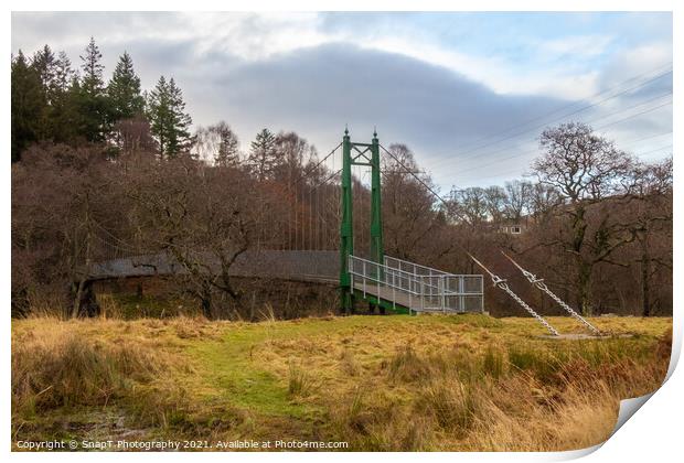 A green wooden suspension bridge on a trail leading into a forest woodland Print by SnapT Photography