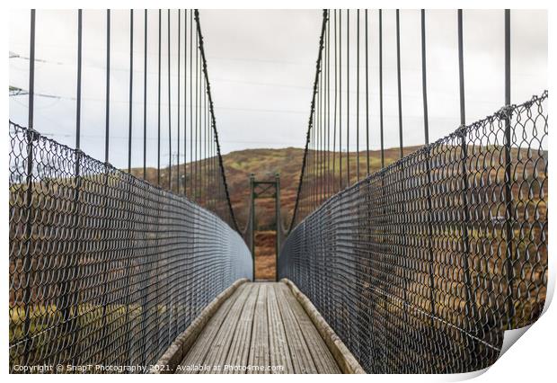 View across a wooden suspension bridge in the Scottish highlands Print by SnapT Photography