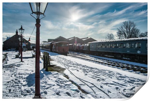 Locomotives on a snow-covered station platform Print by Stuart Chard