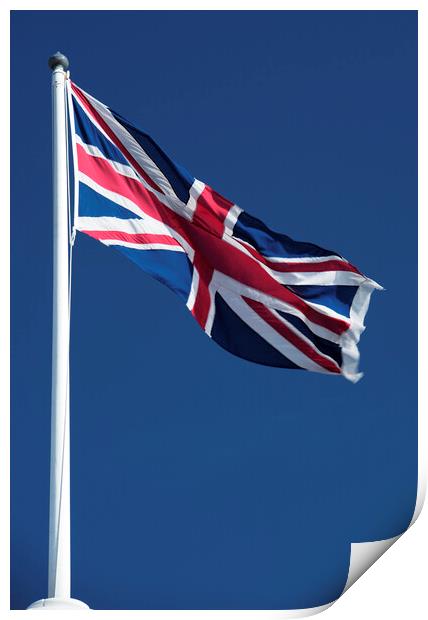 Union Jack flying against blue sky Print by Neil Overy