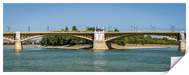 Yellow bridge with tram crossing over Danube River, Budapest, Hungary. Print by Maggie Bajada