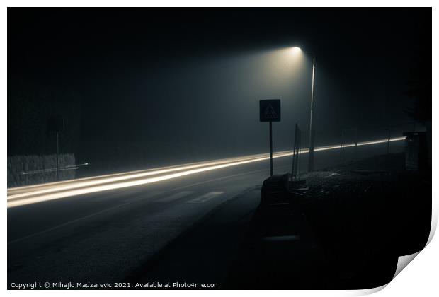 Dark foggy city street at night with a light trail Print by Mihajlo Madzarevic