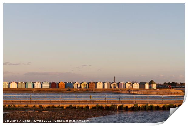 Beach huts at Brightlingsea during golden hour Print by Elaine Hayward
