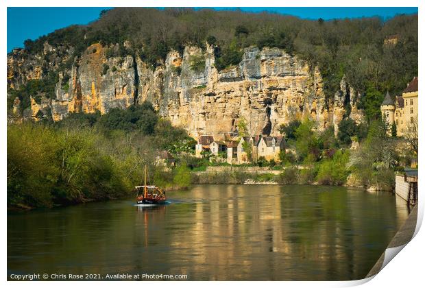 A sightseeing boat passes La Roque-Gageac Print by Chris Rose