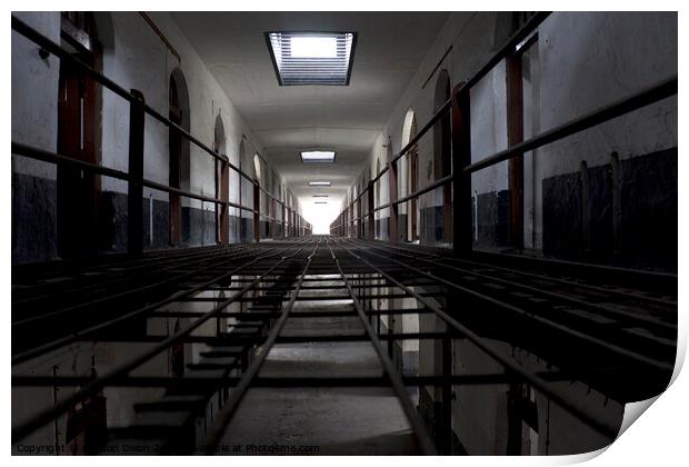 Light at the end of a corridor of cells in an abandoned prison in Kuala Lumpur Print by Gordon Dixon