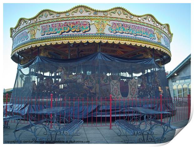 Carousel and it's horses put to bed for the winter at a funfair in Weymouth Print by Gordon Dixon